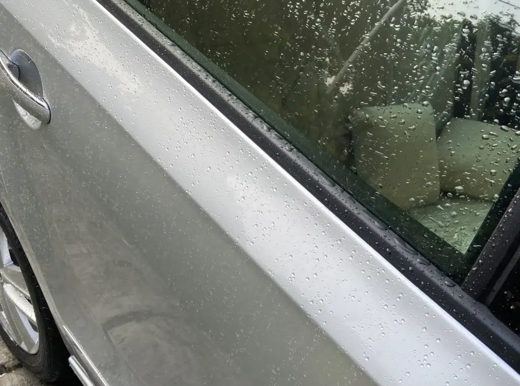 Hydrophobic water-beading effect on ceramic-coated surface.