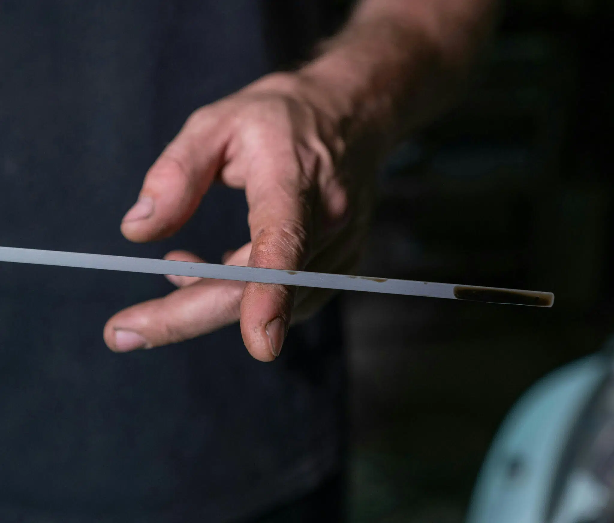 checking engine oil using dipstick before driving
