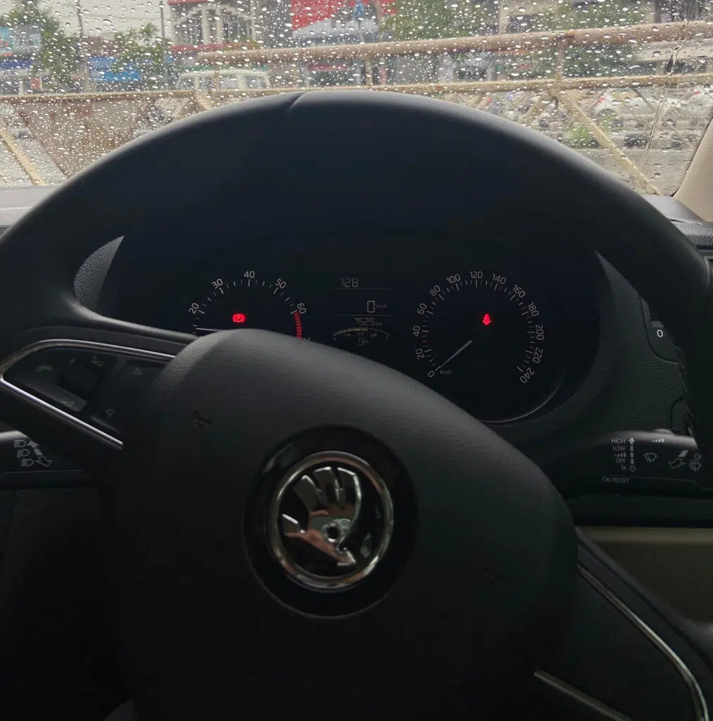 Skoda Rapid dashboard showing handbrake warning light and seatbelt warning light illuminated on 1.0 TSI instrument cluster