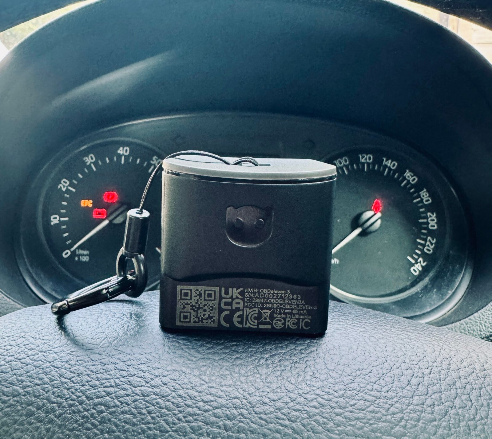 OBDeleven 3 device on the steering wheel of a 2021 Skoda Rapid